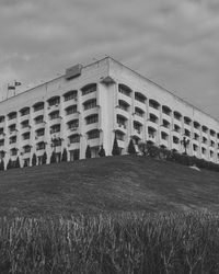 Low angle view of buildings against cloudy sky