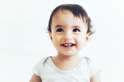 Close-up portrait of cute boy against white background