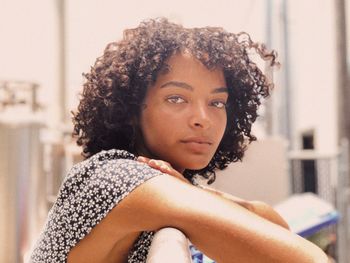 Portrait of woman leaning on railing