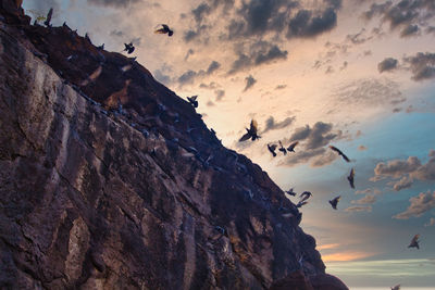 Low angle view of rock formations against sky during sunset