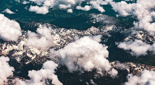 Aerial view of cloudscape over snowcapped mountains