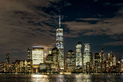 View of full moon rising behind new york city skyline