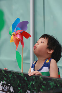 Cute boy playing with pinwheel toy