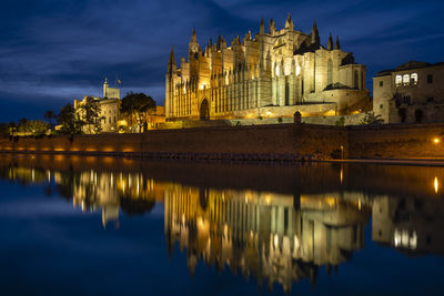 Reflection of building in lake at dusk