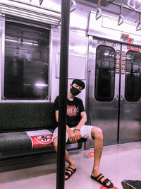 Man sitting on train window