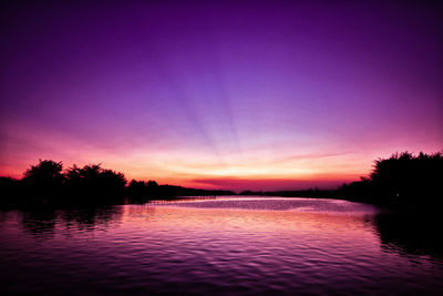 Scenic view of lake against sky at sunset