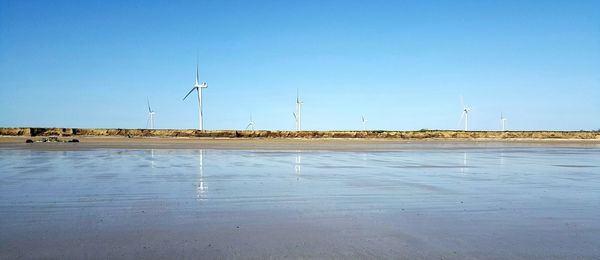 Traditional windmill against clear blue sky