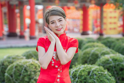 Portrait of smiling woman standing outdoors