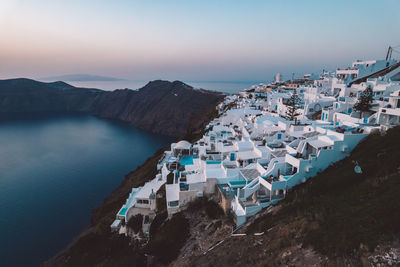 High angle view of townscape by sea against sky