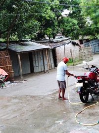 Rear view of people working on building