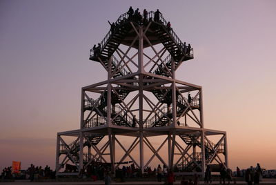 Silhouette of ferris wheel against sky during sunset