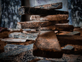 Close-up of rusty stack on wood