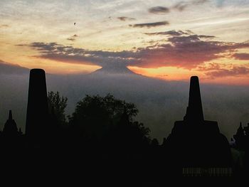 Silhouette temple against sky during sunset