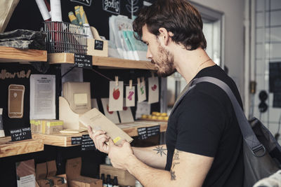 Male customer reading package at organic shop