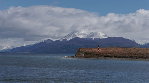 Scenic view of sea and mountains against sky