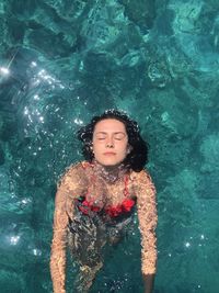 High angle view of woman swimming in pool