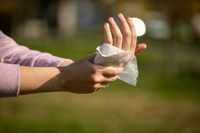 Close-up of hand holding paper outdoors