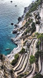 High angle view of rocks on sea shore