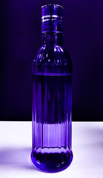 Close-up of glass bottle against blue background