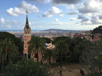 Panoramic view of trees and buildings against sky