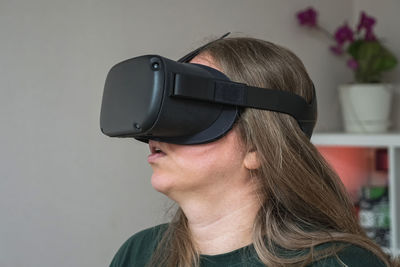 Close-up of a girl's head in a virtual reality helmet. a woman travels in the meta universe