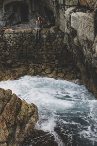 Rear view of people walking on rock