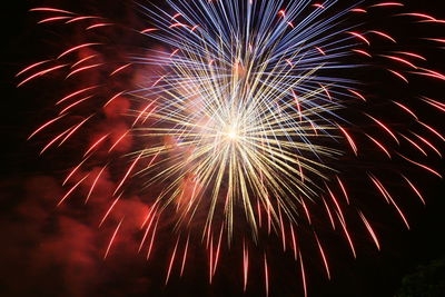 Low angle view of firework display at night