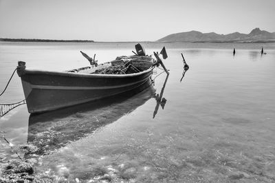 Boats moored on sea against sky