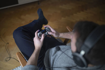 Man's hands holding game control