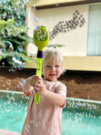 Portrait of cute girl playing with christmas tree