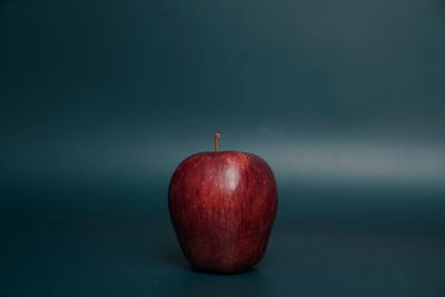 Close-up of apple against red background