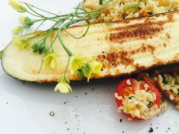 Close-up of zucchini with tomato in plate