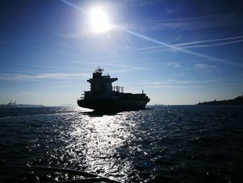 Ship sailing on sea against sky