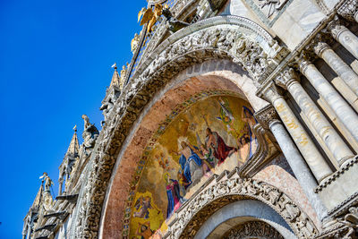 Low angle view of carving on building against sky