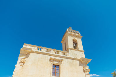 Low angle view of historic building against clear blue sky