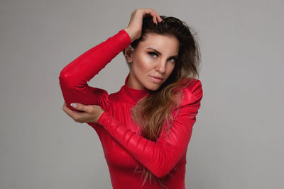 Portrait of beautiful young woman against white background