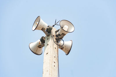 Low angle view of telephone pole against clear sky