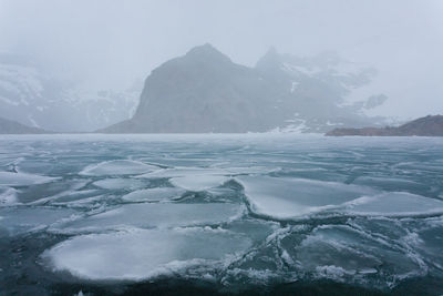 Scenic view of frozen lake against sky