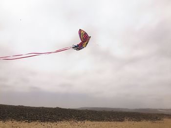 Low angle view of helicopter flying in sky