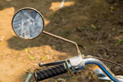 Close-up of bicycle wheel on field