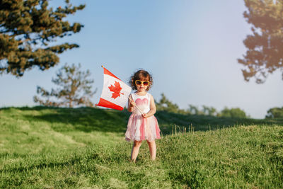Full length of a girl standing on field