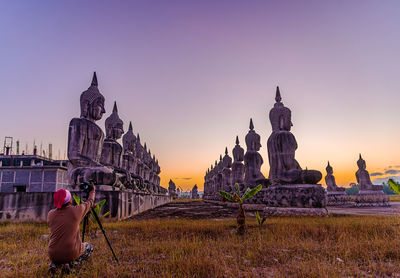 Rear view of buildings against sky during sunset