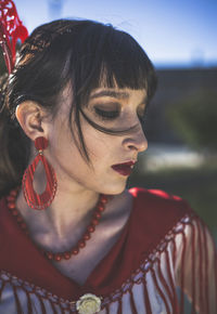 Close-up of young woman in traditional clothes outdoors