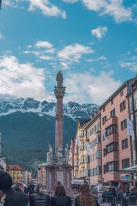 Statue of buildings against cloudy sky