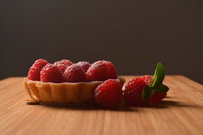 Close-up of strawberries on table against black background