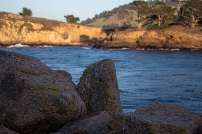 Rocks on beach against sky