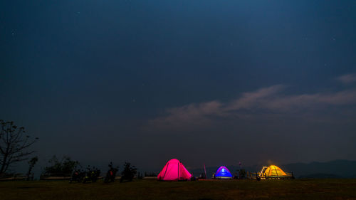 Illuminated tent against sky at night