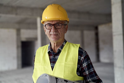 Portrait of smiling engineer standing at construction site