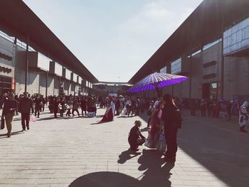 People on sidewalk in city