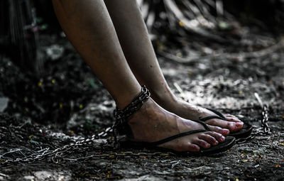 Low section of woman standing on field